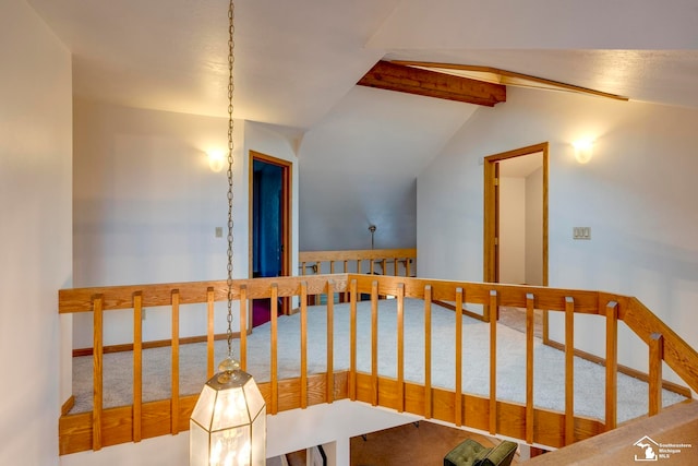 hall with carpet and vaulted ceiling with beams