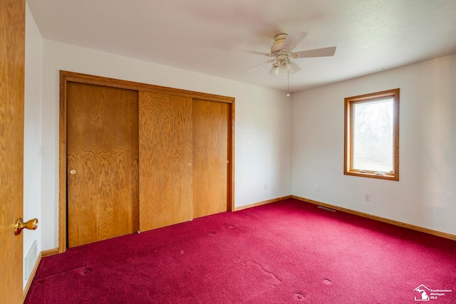 unfurnished bedroom featuring carpet, a closet, and ceiling fan