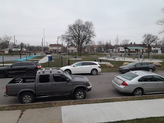 view of vehicle parking featuring a lawn