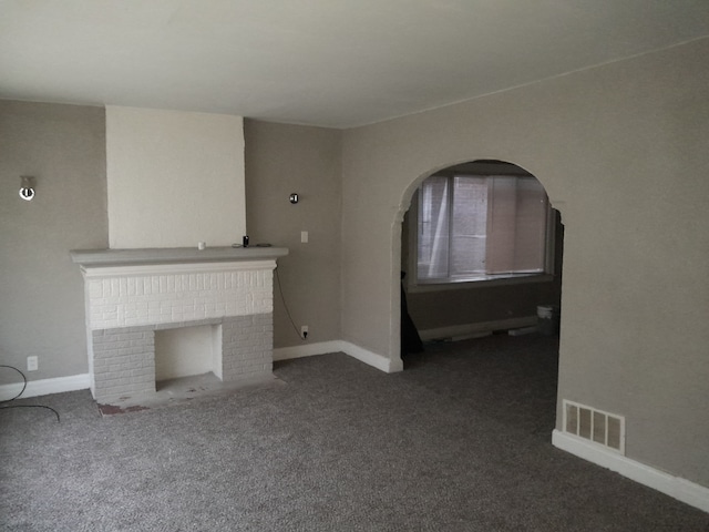 unfurnished living room featuring carpet and a fireplace