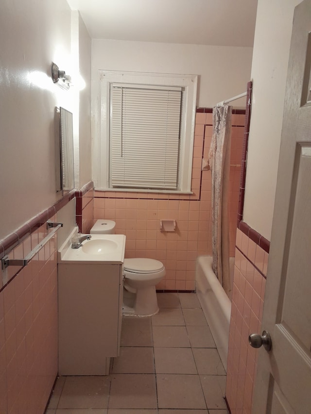 full bathroom featuring tile patterned floors, vanity, and tile walls