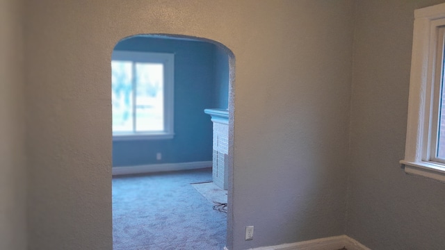 hall featuring light colored carpet