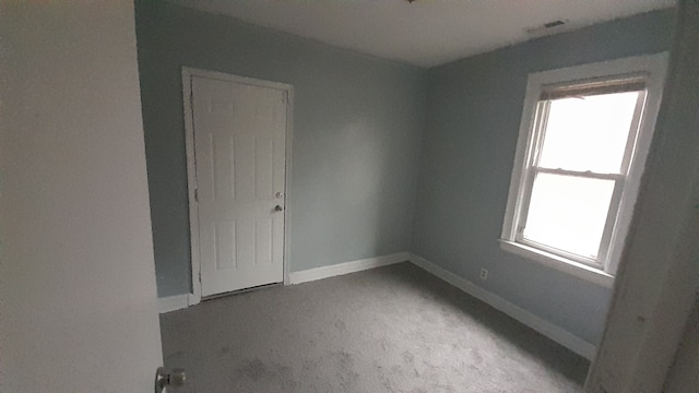 spare room with light colored carpet and plenty of natural light