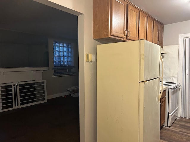 kitchen featuring dark wood-type flooring and white appliances