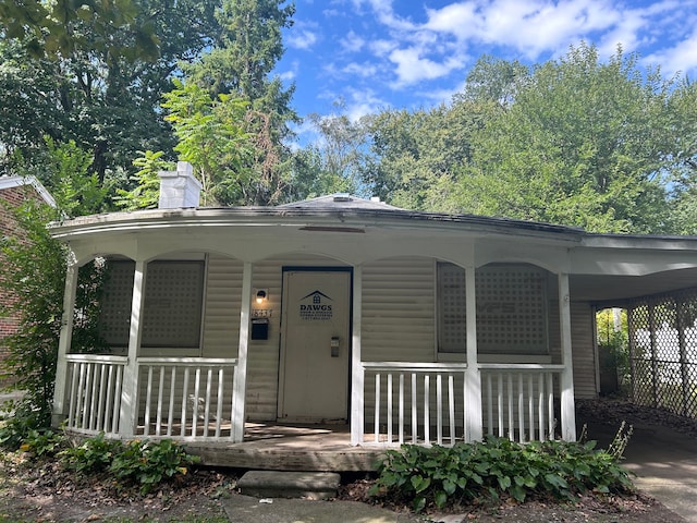 view of front of home featuring covered porch and a carport