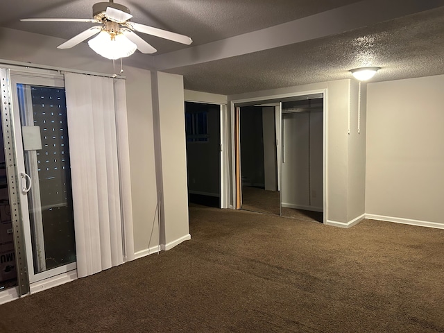 interior space featuring ceiling fan and a textured ceiling