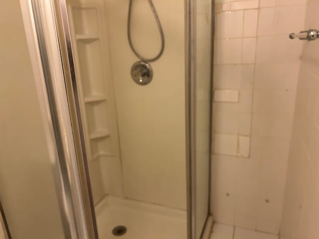 bathroom with a tile shower