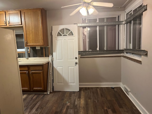 doorway featuring ceiling fan and dark hardwood / wood-style flooring