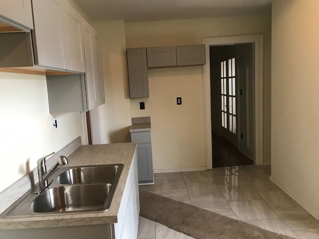 kitchen with gray cabinetry and sink