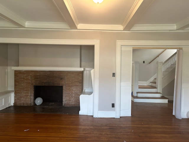 unfurnished living room with beam ceiling, a fireplace, dark hardwood / wood-style flooring, and ornamental molding