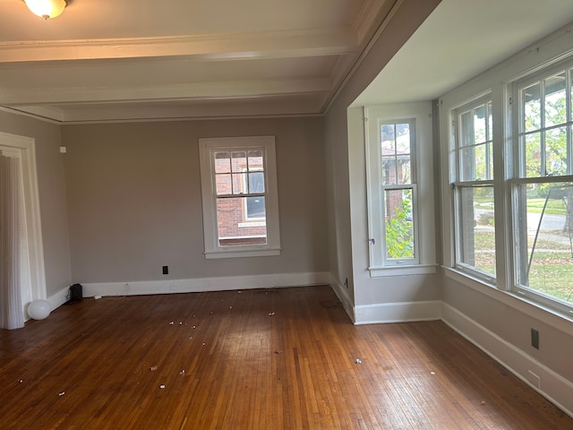 spare room with beam ceiling, dark hardwood / wood-style flooring, and ornamental molding