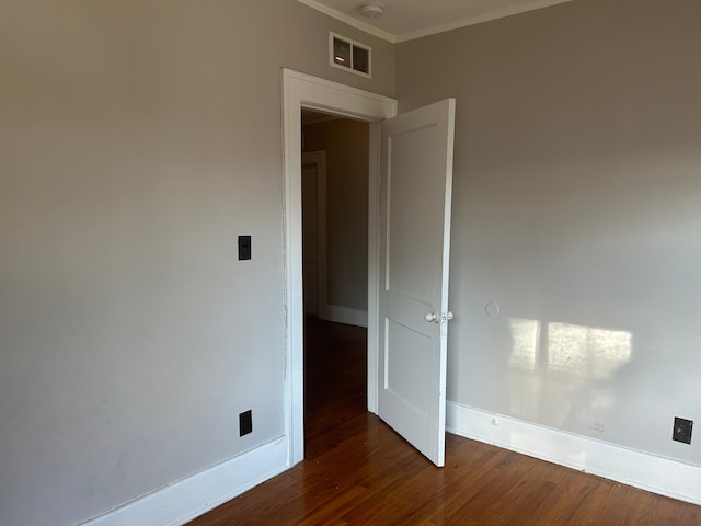 unfurnished room with dark hardwood / wood-style floors and ornamental molding