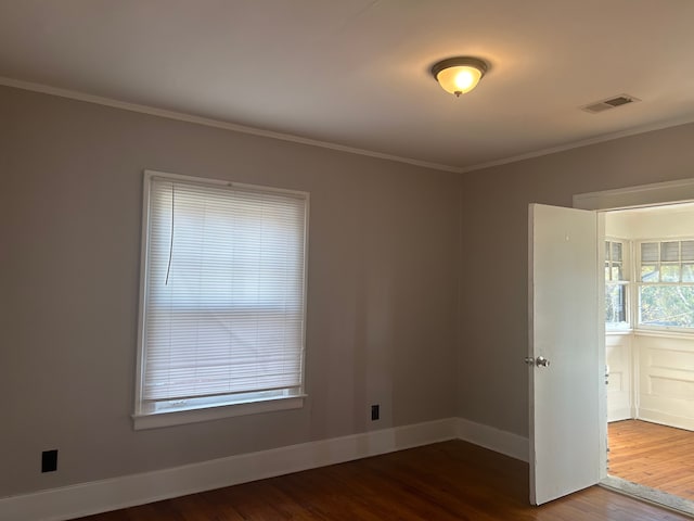 unfurnished room with wood-type flooring and crown molding