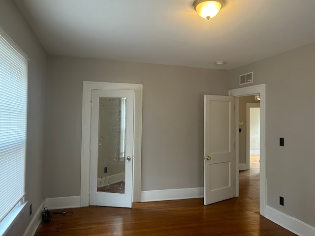 spare room with dark hardwood / wood-style flooring