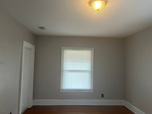 spare room featuring dark hardwood / wood-style flooring