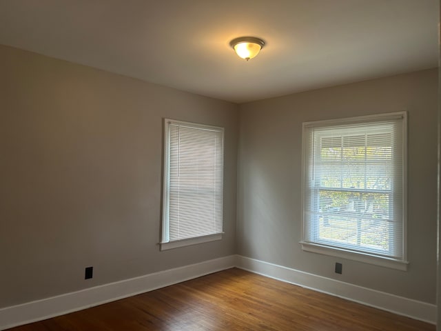 unfurnished room with wood-type flooring