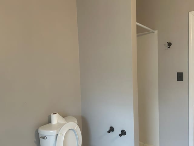 bathroom with toilet and a shower