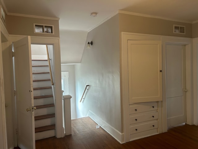 staircase featuring hardwood / wood-style floors and crown molding