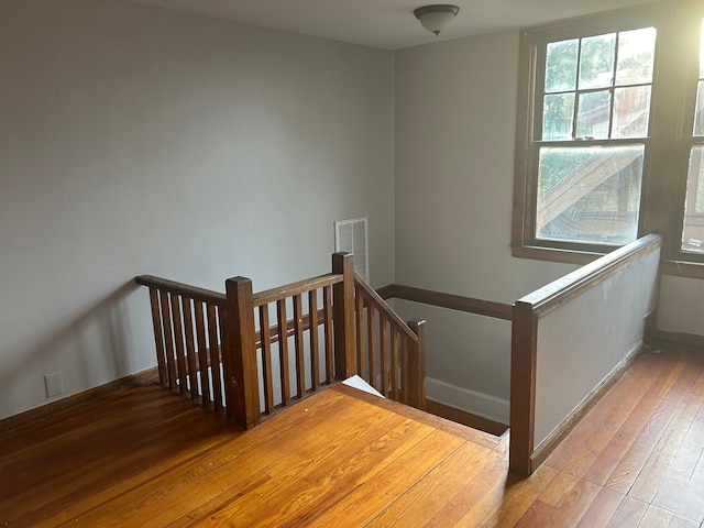 stairs with hardwood / wood-style flooring