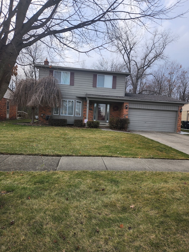 view of front property with a garage and a front yard