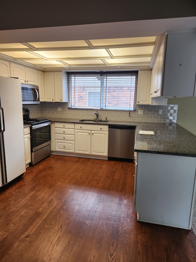 kitchen with dark wood-type flooring, sink, a wealth of natural light, appliances with stainless steel finishes, and white cabinetry