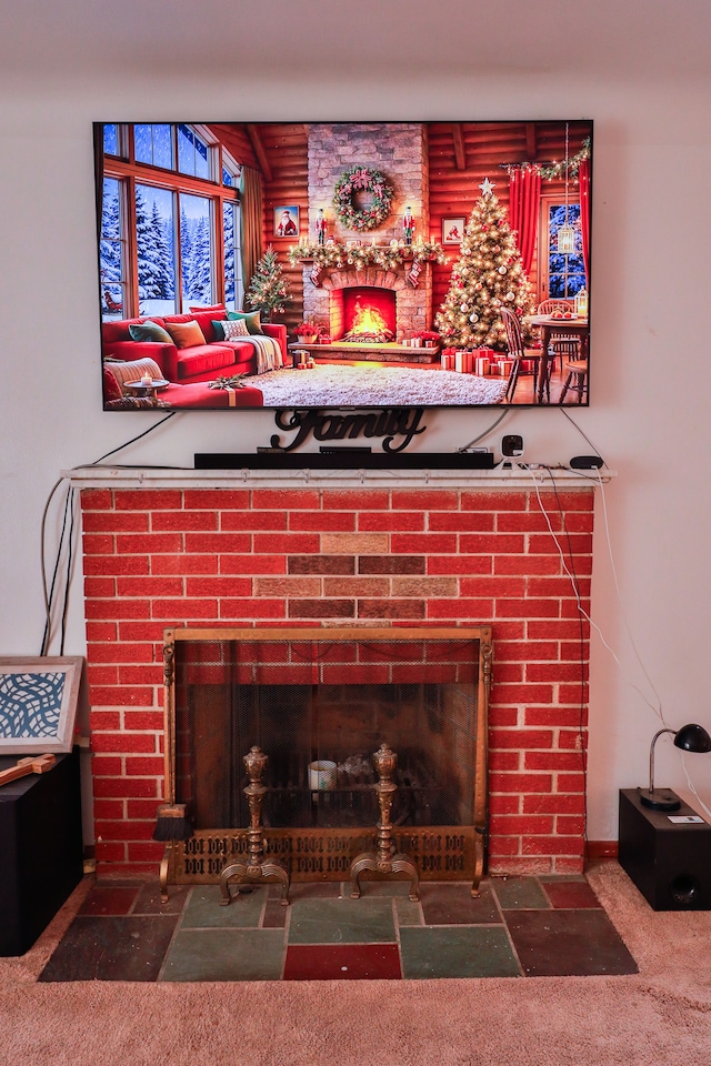 details with carpet and a brick fireplace