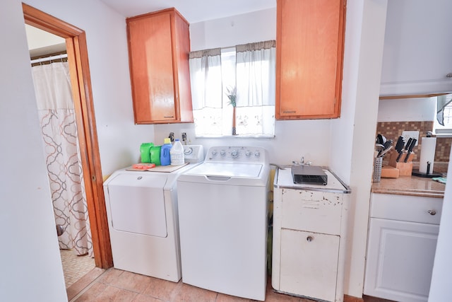 washroom featuring washer and dryer and cabinets