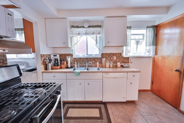 kitchen featuring backsplash, white cabinetry, sink, and white appliances