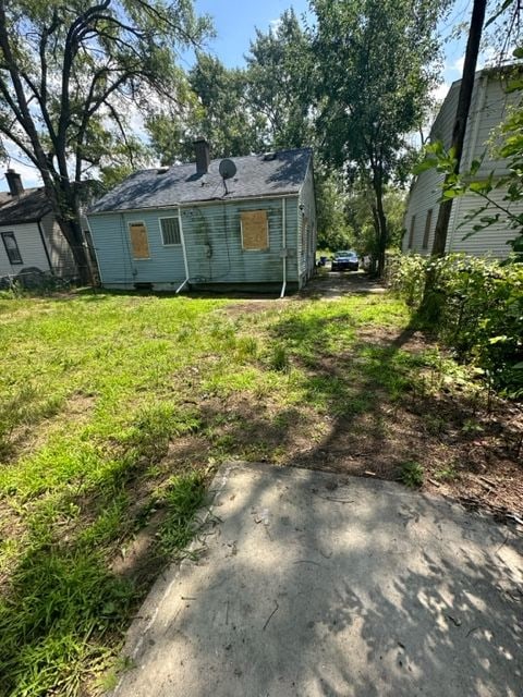 rear view of house featuring a lawn