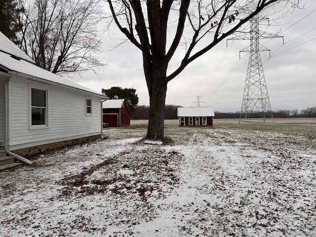 snowy yard with an outbuilding