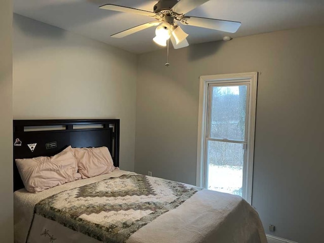 bedroom featuring multiple windows and ceiling fan