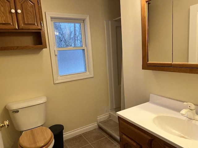 bathroom featuring tile patterned flooring, vanity, and toilet