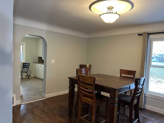 dining area with dark hardwood / wood-style floors