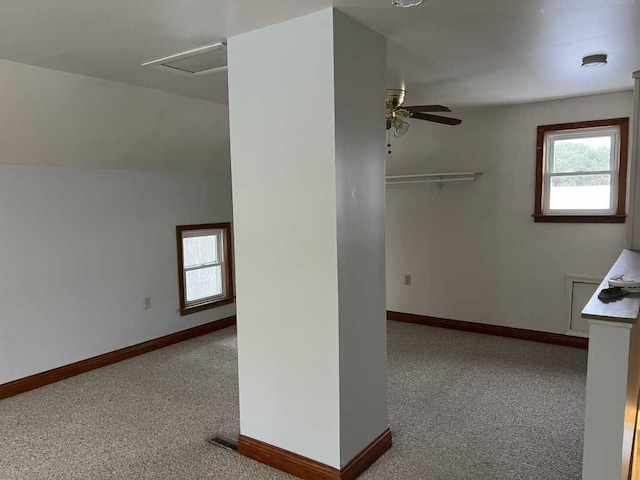 empty room with vaulted ceiling, light carpet, and ceiling fan