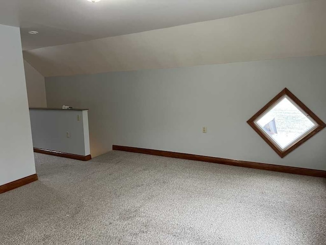 additional living space with lofted ceiling and carpet floors