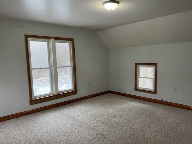 additional living space featuring lofted ceiling and carpet floors