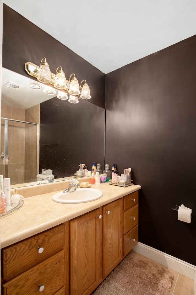 bathroom featuring tile patterned floors, vanity, and a shower with shower door