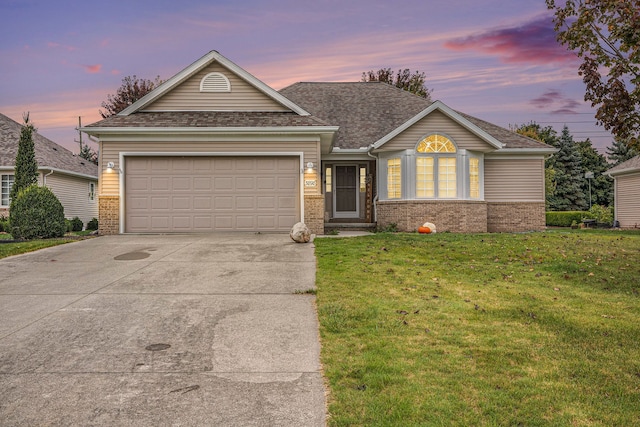 view of front facade with a garage and a lawn