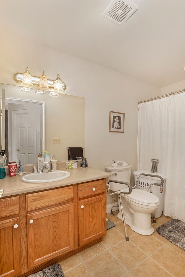 bathroom featuring tile patterned flooring, vanity, and toilet