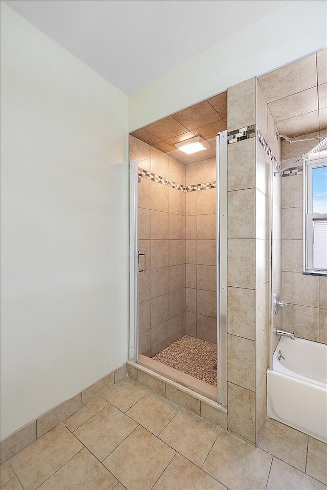 bathroom featuring tile patterned floors and shower with separate bathtub