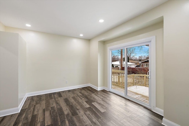 spare room with dark hardwood / wood-style flooring