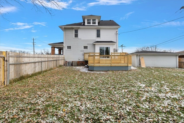 rear view of property featuring a lawn, cooling unit, and a deck