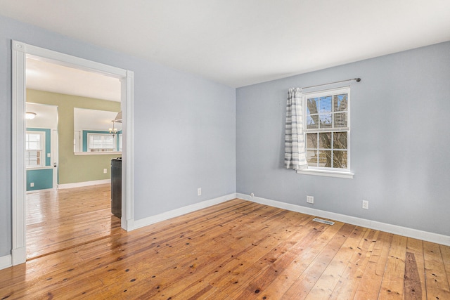 empty room with plenty of natural light and light wood-type flooring