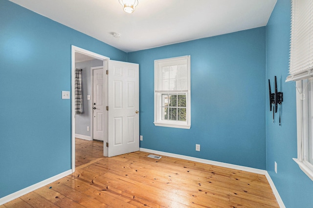 spare room featuring hardwood / wood-style flooring