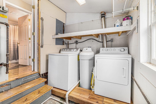 clothes washing area featuring independent washer and dryer and wood-type flooring