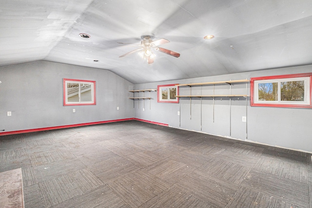 interior space with ceiling fan and vaulted ceiling