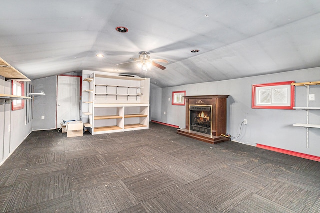 interior space with ceiling fan and lofted ceiling