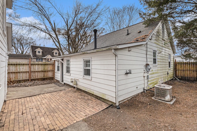 view of side of home featuring a patio and cooling unit