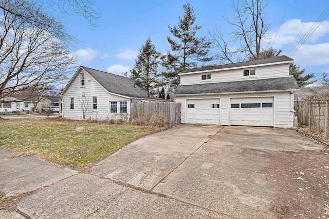 view of side of property with a lawn and a garage