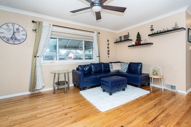 living room featuring ceiling fan, light hardwood / wood-style floors, and crown molding